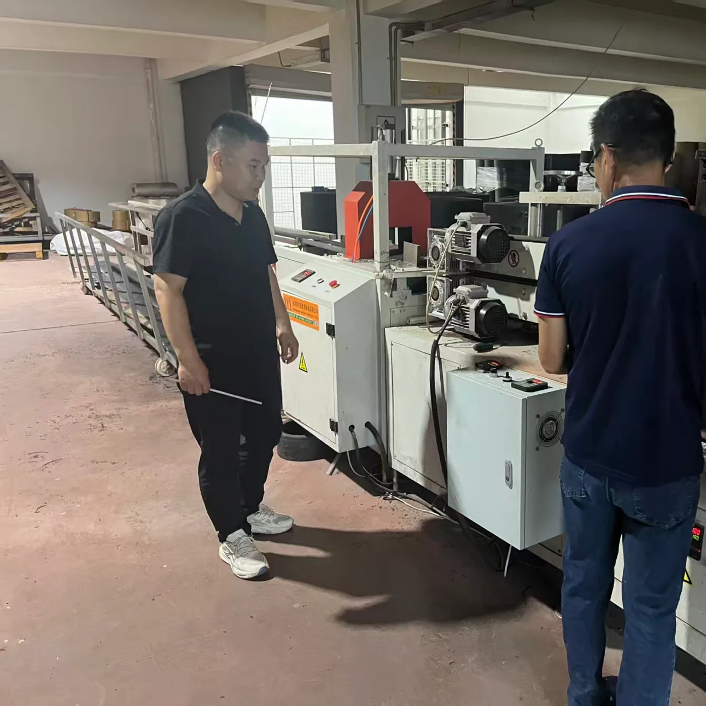 Chinese technicians operating aquaponics component production equipment at the YAFAN factory